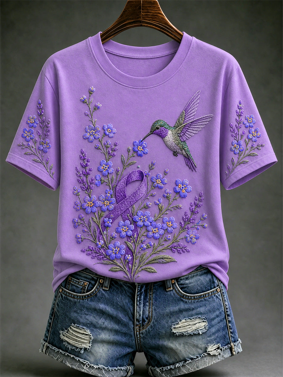Damen-T-Shirt in Lila mit Blumen- und Kolibri-Print zur Sensibilisierung für die Alzheimer-Krankheit