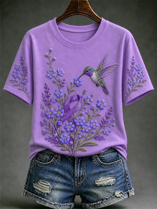 Damen-T-Shirt in Lila mit Blumen- und Kolibri-Print zur Sensibilisierung für die Alzheimer-Krankheit