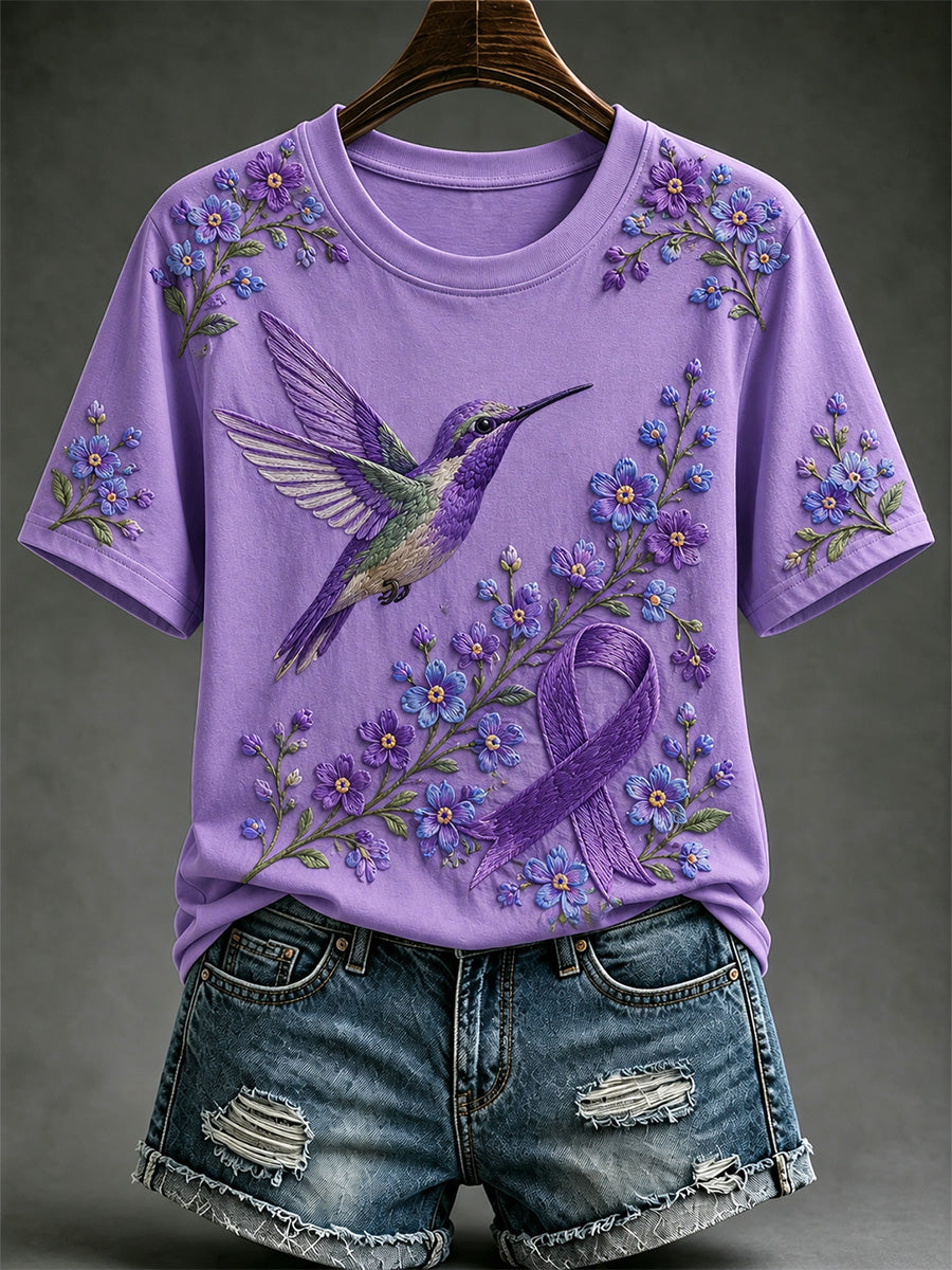 Damen-T-Shirt in Lila mit Blumen- und Kolibri-Print zur Sensibilisierung für die Alzheimer-Krankheit