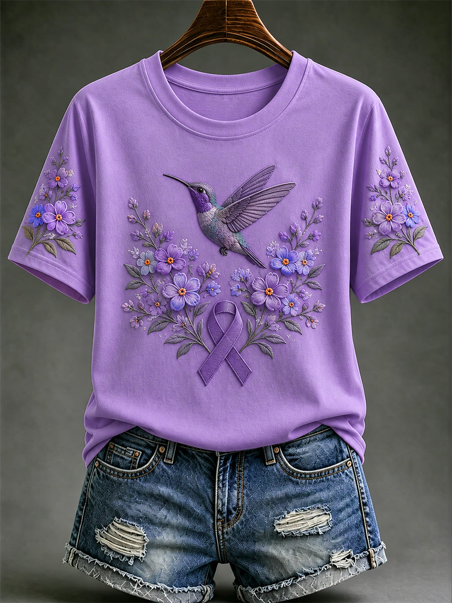 Damen-T-Shirt in Lila mit Blumen- und Kolibri-Print zur Sensibilisierung für die Alzheimer-Krankheit
