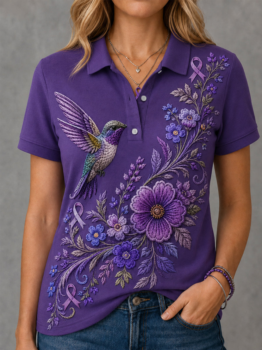 Damen-Polo in Lila mit Blumen- und Kolibri-Print zur Sensibilisierung für die Alzheimer-Krankheit